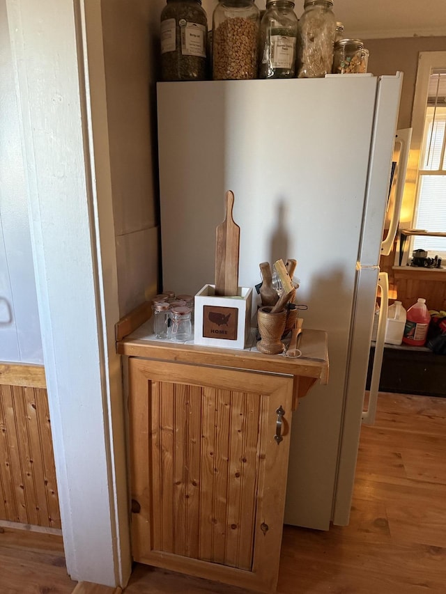 room details with hardwood / wood-style flooring and white refrigerator