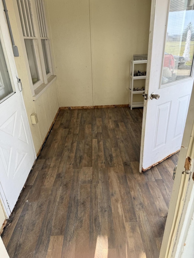 corridor with dark hardwood / wood-style flooring