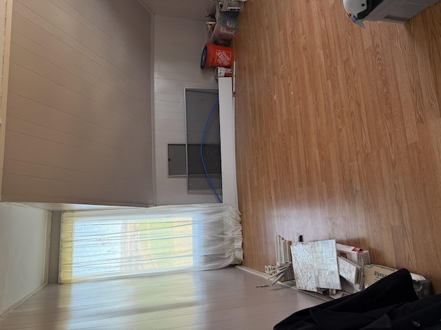 unfurnished bedroom featuring wooden walls