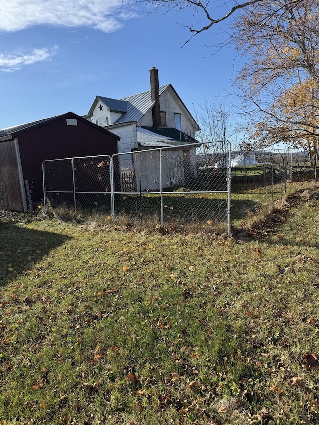 view of yard with fence, an outbuilding, and an outdoor structure