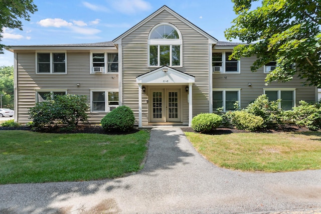 view of front facade with french doors and a front lawn