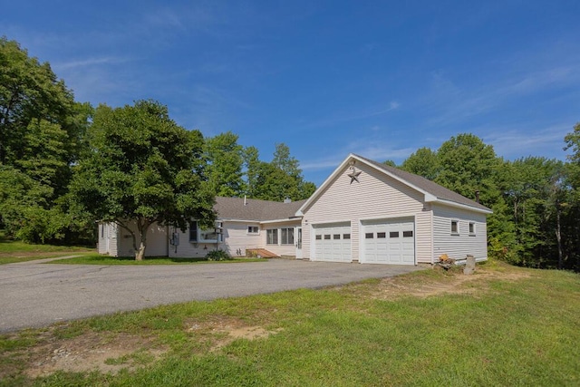 view of front of property with a garage and a front lawn