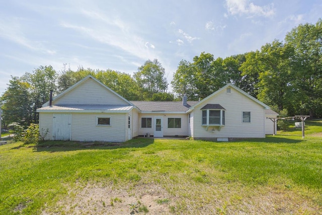 back of house with a yard