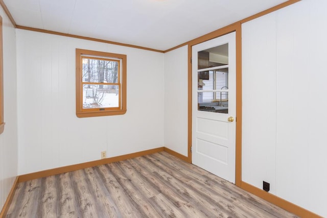 spare room featuring ornamental molding and hardwood / wood-style floors