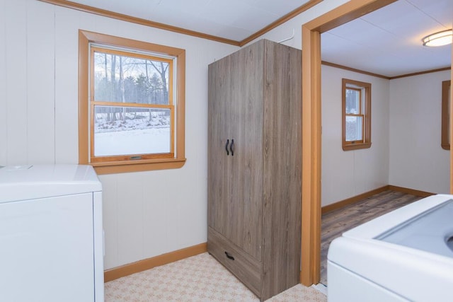 clothes washing area featuring washer / dryer and ornamental molding