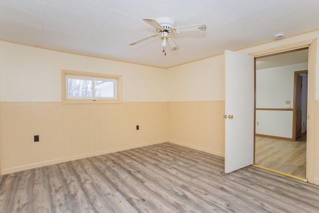 spare room featuring ceiling fan and light hardwood / wood-style floors