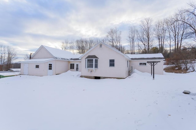 view of snow covered rear of property