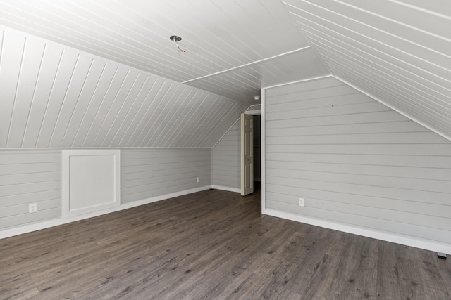 bonus room featuring lofted ceiling and dark wood-type flooring