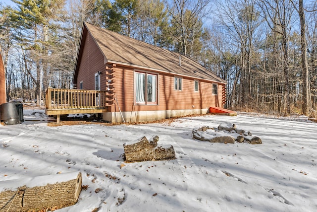 view of snow covered exterior featuring a wooden deck