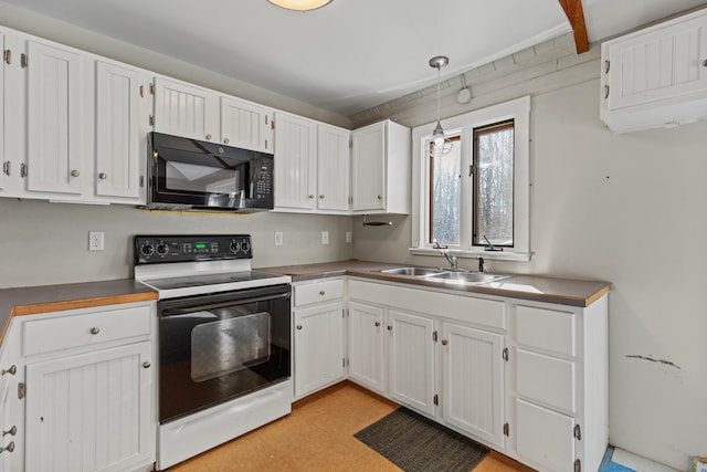 kitchen featuring range with electric stovetop, pendant lighting, white cabinets, and sink