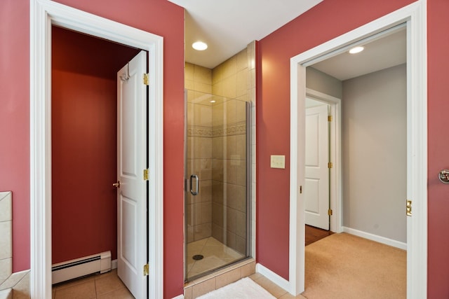 bathroom with a baseboard heating unit, a shower with door, and tile patterned floors