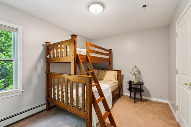 bedroom with light colored carpet, a baseboard radiator, and multiple windows