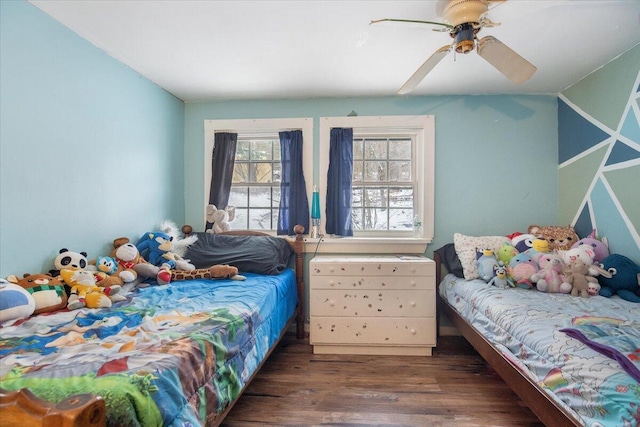 bedroom with ceiling fan and dark wood-type flooring