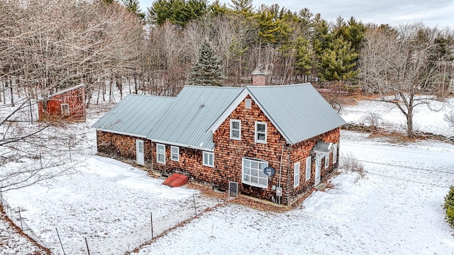 snow covered property featuring central AC unit