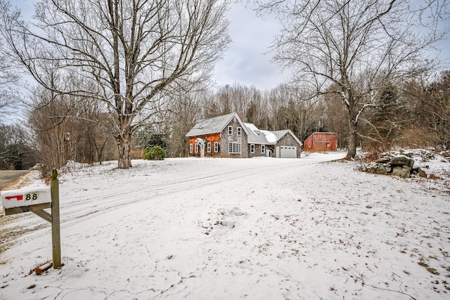 yard covered in snow featuring a garage