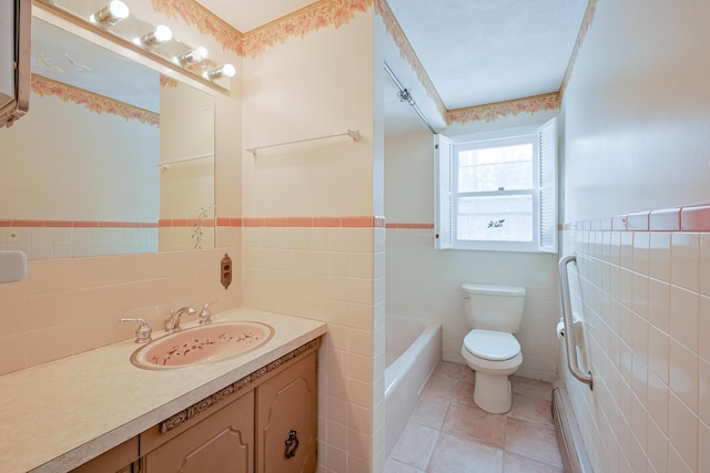 bathroom featuring tile patterned flooring, tile walls, toilet, a tub to relax in, and vanity