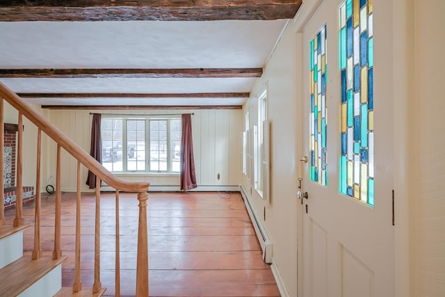 foyer entrance with a baseboard heating unit, beamed ceiling, and light hardwood / wood-style flooring