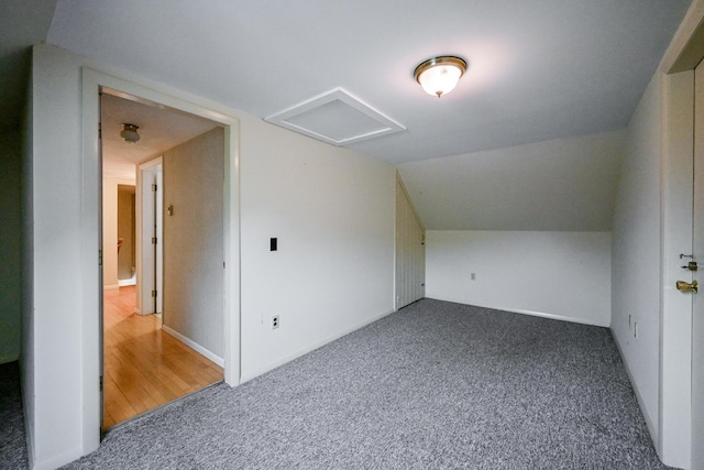 bonus room with carpet floors and vaulted ceiling