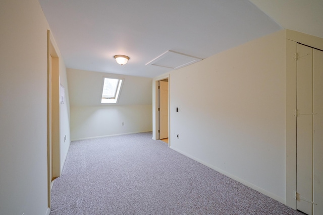 bonus room featuring lofted ceiling and light colored carpet