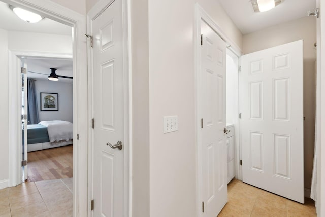 hall featuring light tile patterned floors