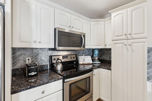 kitchen featuring white cabinets, appliances with stainless steel finishes, and tasteful backsplash