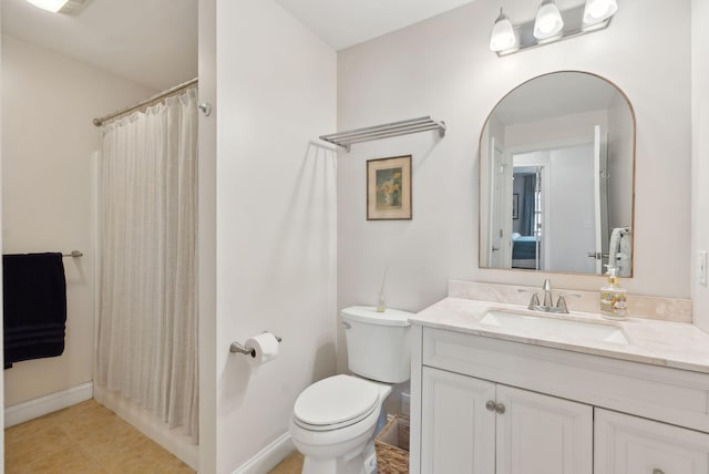 bathroom with toilet, curtained shower, and vanity