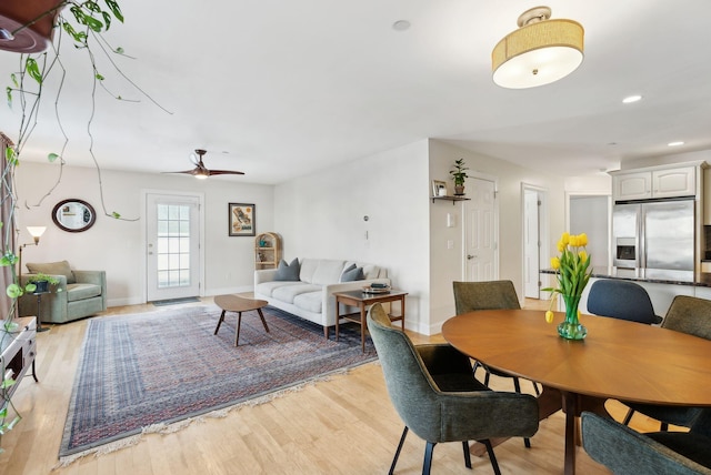 dining area with ceiling fan and light wood-type flooring