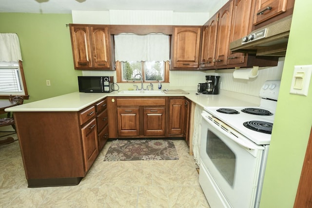 kitchen featuring kitchen peninsula, white electric range oven, and sink