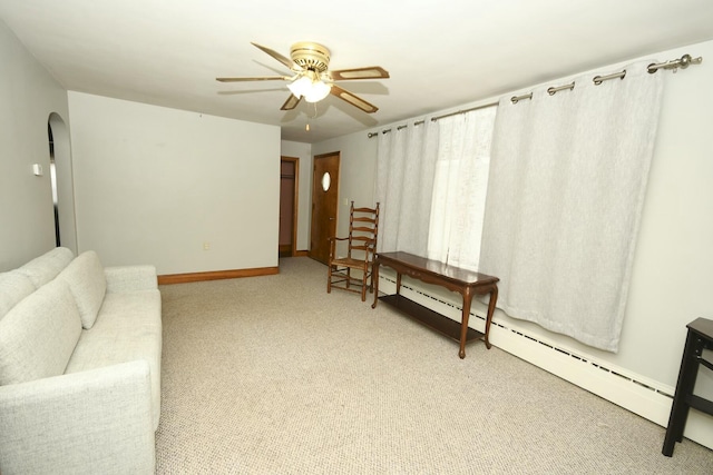 living room with ceiling fan, light colored carpet, and baseboard heating