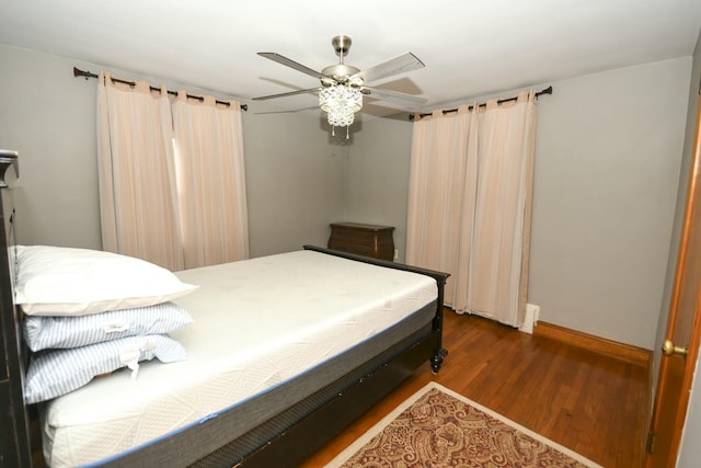 bedroom with dark wood-type flooring and ceiling fan