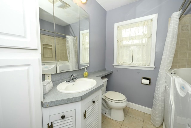 full bathroom featuring vanity, shower / bath combo with shower curtain, tile patterned floors, and toilet