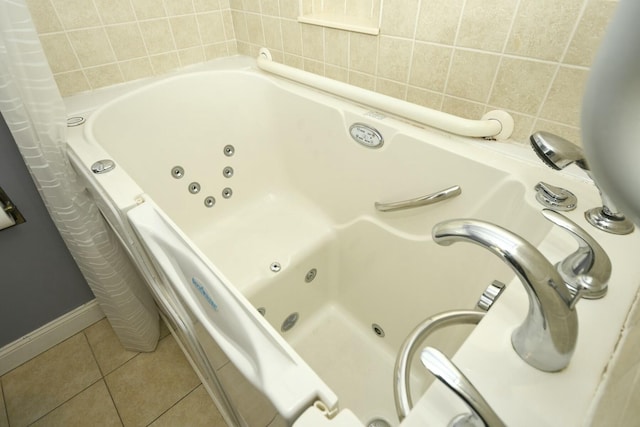 bathroom with tile walls, a bathing tub, tile patterned flooring, and decorative backsplash