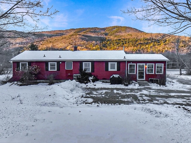 snow covered house with a mountain view