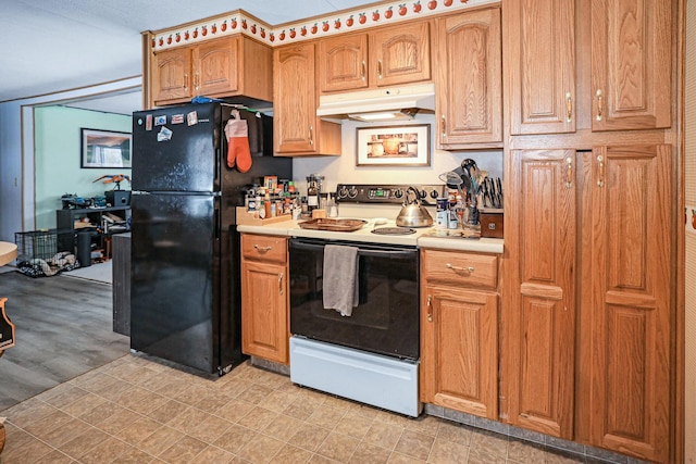 kitchen with electric stove, black fridge, and light wood-type flooring