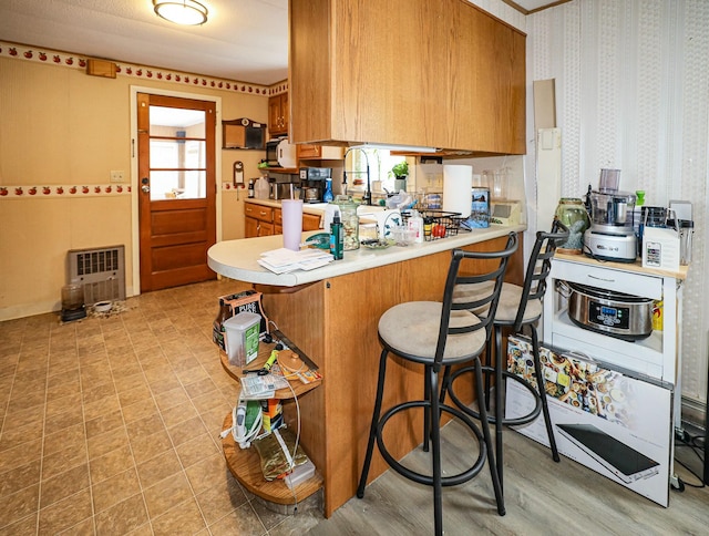 kitchen with kitchen peninsula and a breakfast bar