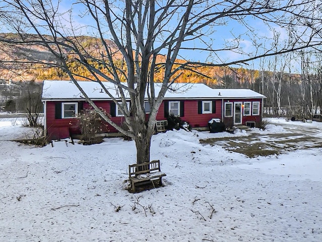 view of snow covered rear of property