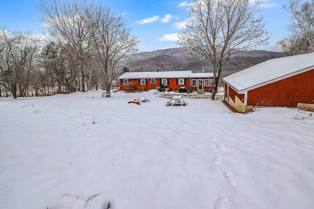 snow covered house with a mountain view