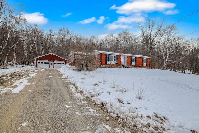 view of front of property with a garage and an outdoor structure