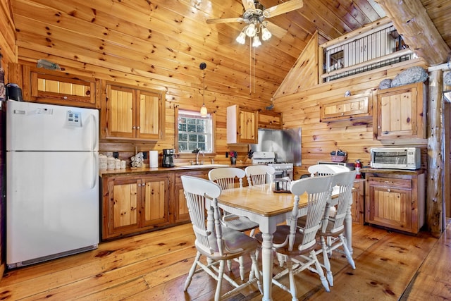 dining room featuring wooden ceiling, wooden walls, light wood-type flooring, and ceiling fan