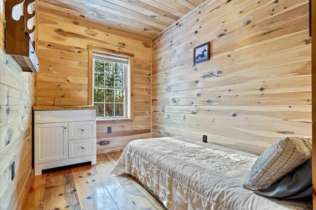 bedroom with wood ceiling, wooden walls, and wood-type flooring