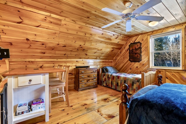 bedroom featuring wooden ceiling, wood walls, vaulted ceiling, ceiling fan, and light hardwood / wood-style flooring