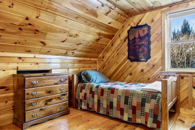 bedroom featuring wood walls, wood ceiling, and hardwood / wood-style floors