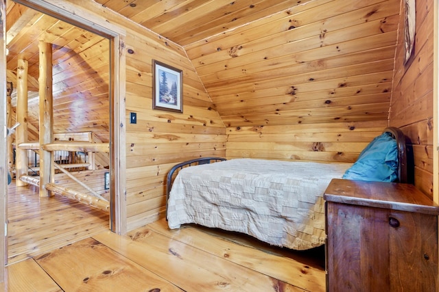 bedroom featuring wood-type flooring, wooden walls, and wood ceiling