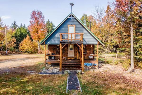 log-style house with covered porch