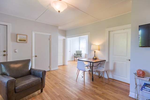 dining room featuring light wood finished floors and baseboards