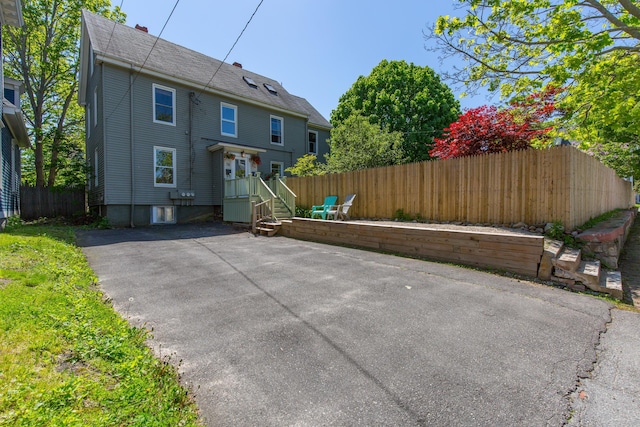 rear view of house with a patio area and fence