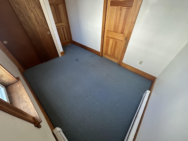 interior space with baseboard heating and light colored carpet