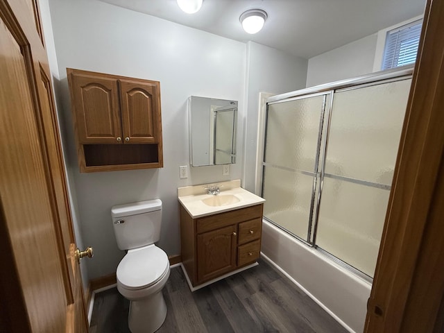 full bathroom with shower / bath combination with glass door, toilet, vanity, and hardwood / wood-style floors