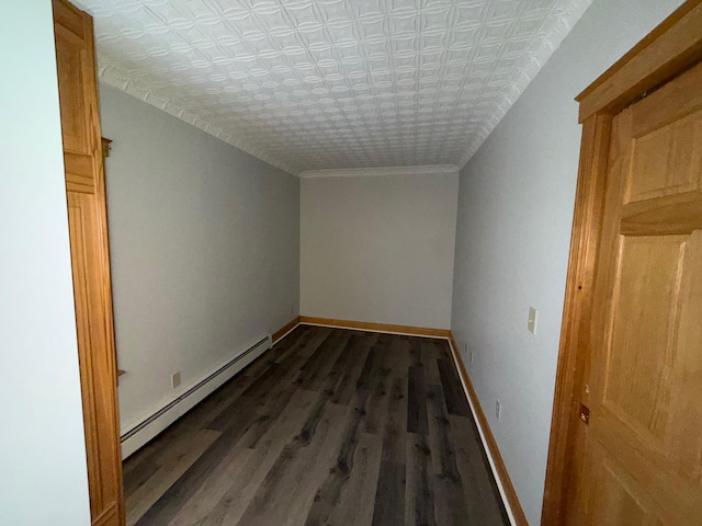 bonus room with a baseboard heating unit, a textured ceiling, and dark hardwood / wood-style floors