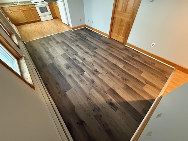 details with sink, fridge, hardwood / wood-style flooring, and white electric range oven